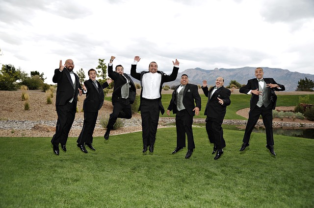 Groom and groomsmen jumping